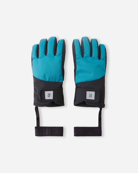 Top view of a pair of Reima Hankas kids' waterproof ski gloves in vibrant aquatic blue and black, featuring adjustable Velcro wrist straps with reflective Reima logos and elastic security leashes on a light background.