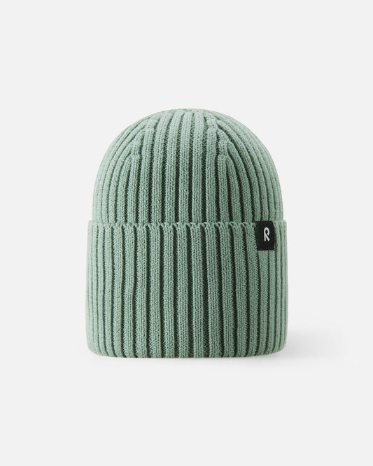Front view of the Reima Hattara kids' organic cotton ribbed beanie in stone green, featuring a stylish folded brim and a branded black Reima logo tag.