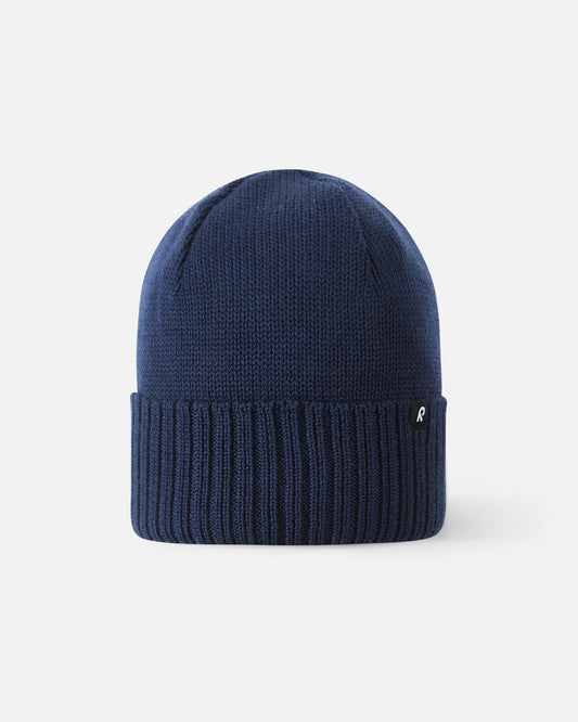 Front view of the Reima Kalotti kids' merino wool beanie hat in classic navy blue, featuring a ribbed fold-over brim.