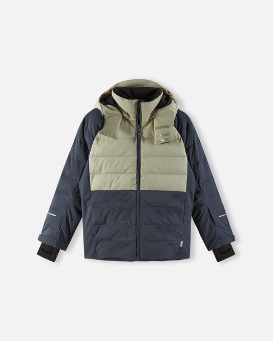 The primary product photograph of the fully insulated Reima Kuosku kids ski jacket in Soft black, showcasing a complete front view. The jacket features a clean color-blocked design with a light taupe upper panel, a dark charcoal quilted body, an insulated hood, a high protective collar with a distinct textured strap, a full-length zipper, horizontal quilting, and adjustable cuffs with inner lycra sleeves. This definitive image represents the complete insulated design for high-performance winter protection.