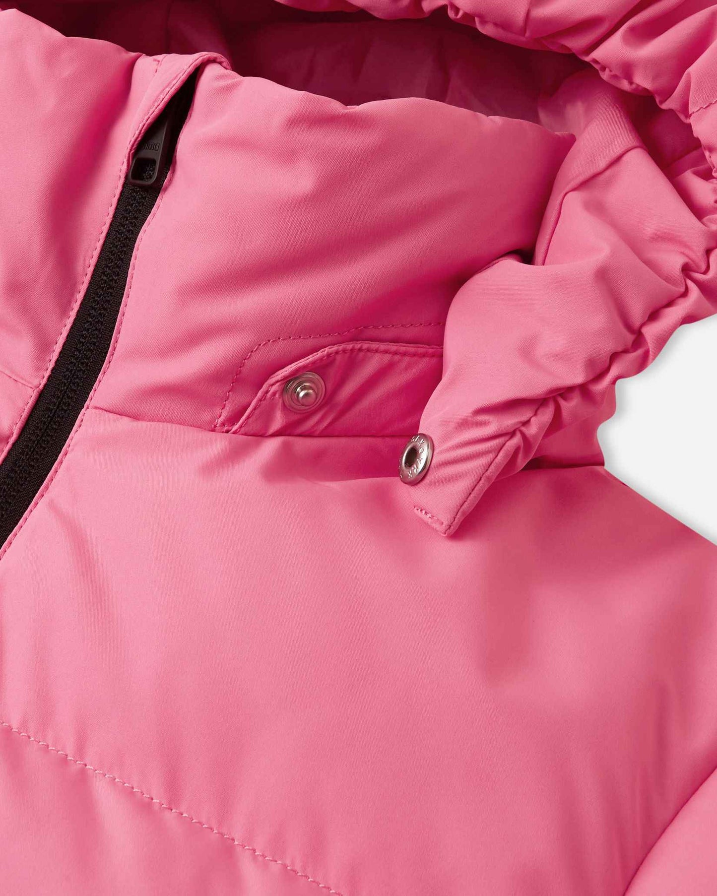 Close-up view of the collar on the soft coral pink Reima Paimio children's down jacket, revealing the metallic snap buttons that allow the insulated hood to safely and easily detach if it catches on tree branches or playground equipment.