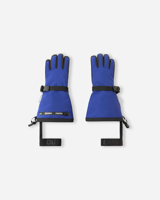 Flat lay view of the backs of the twilight blue Reima Skimba kids' ski gloves, featuring an extra-long snow-blocking gauntlet cuff, an adjustable wrist strap, and elastic safety wrist leashes.