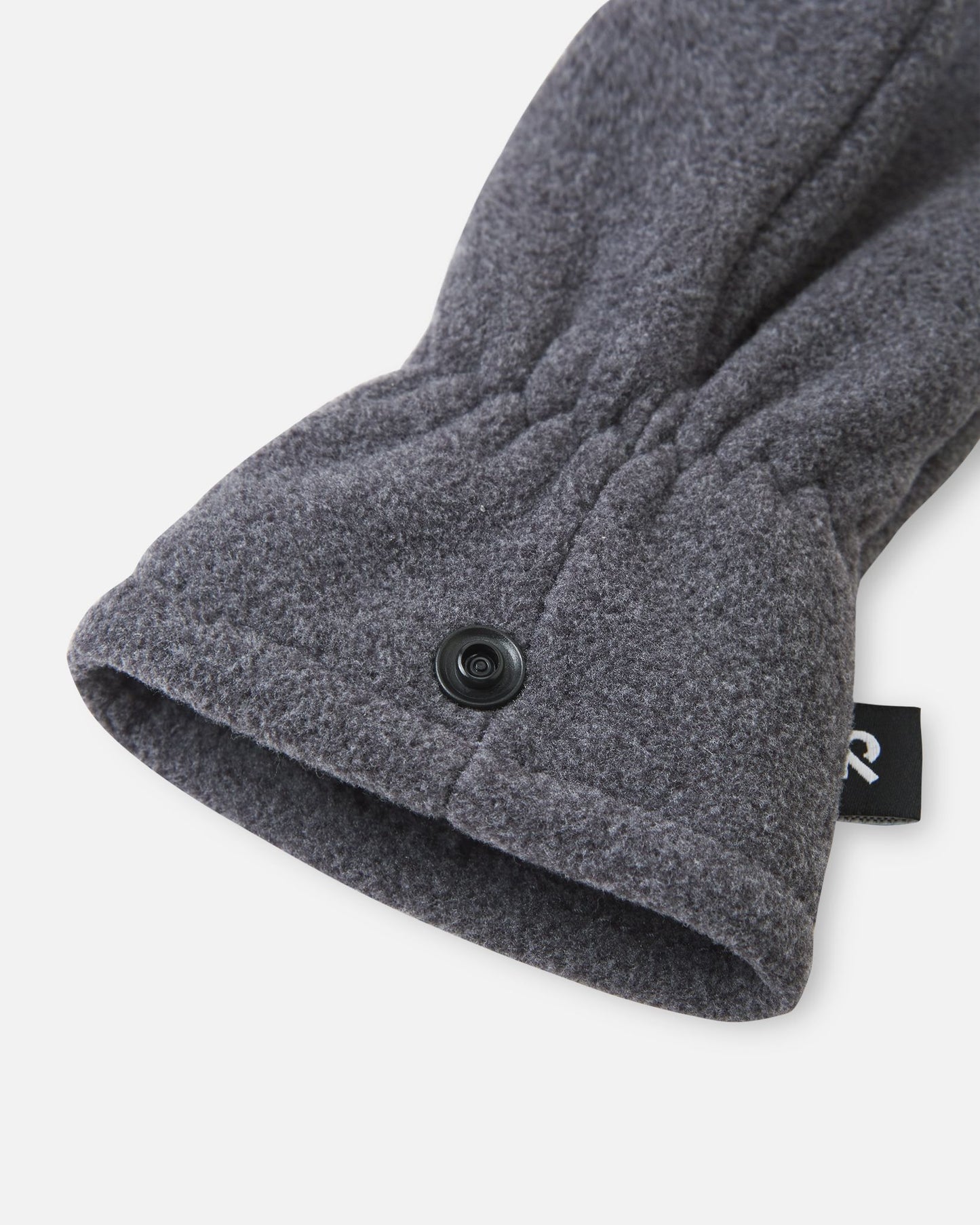 Close-up macro detail of the elastic wrist gather and the durable snap closure on the black melange Reima Tumpus kids' winter fleece mitten.