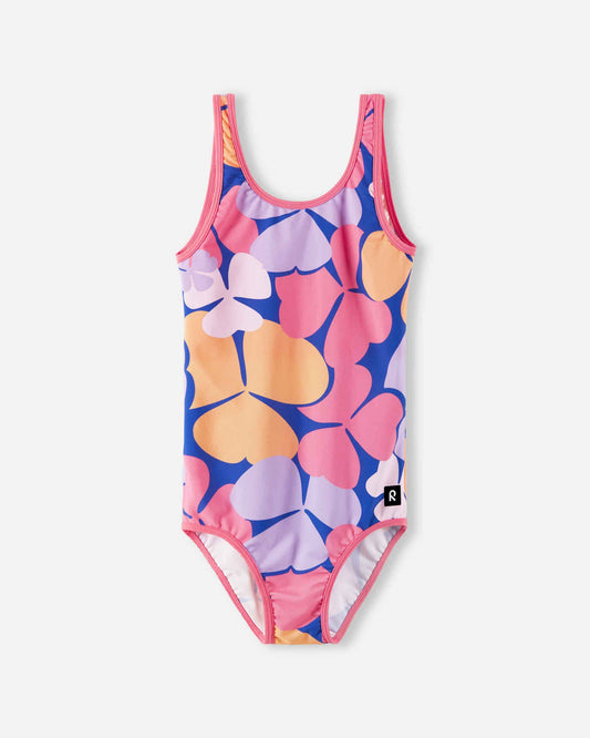 Front view of the Reima Uimaan girls' one-piece swimsuit, featuring a vibrant soft coral, pink, and purple oversized floral print, designed with comfortable wide straps and quick-dry UV-protective fabric.