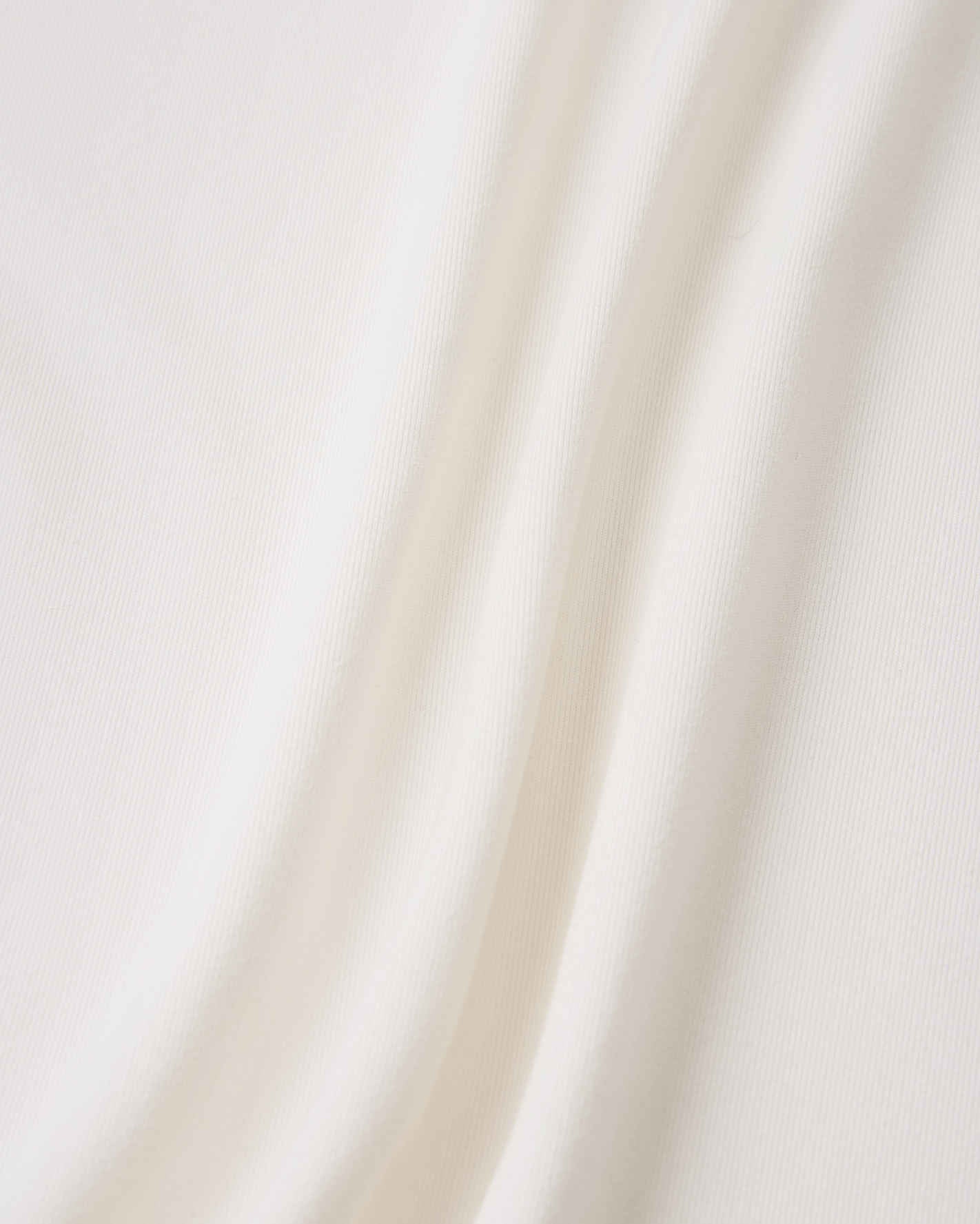 Extreme close-up of the soft, off-white cooling fabric on the Reima Vauhdikas kids' summer t-shirt, demonstrating the breathable knit structure that keeps children cool and dry.