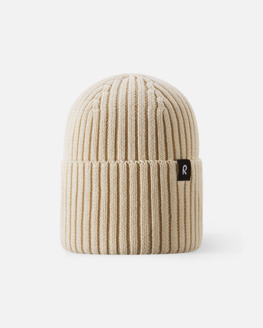 Front view of the Reima Hattara kids' organic cotton ribbed beanie in neutral birch beige, featuring a stylish folded cuff and a subtle black Reima logo tag.