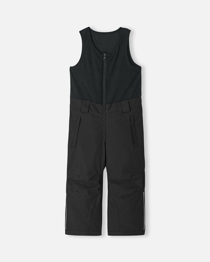 Front flat lay view of the classic black Reima Alppi kids' snow bib pants. The image highlights the integrated warm fleece vest top, secure center zipper, and reinforced lower legs built for rugged winter conditions.