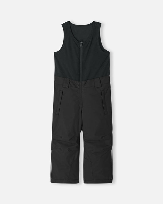 Front flat lay view of the classic black Reima Alppi kids' snow bib pants. The image highlights the integrated warm fleece vest top, secure center zipper, and reinforced lower legs built for rugged winter conditions.