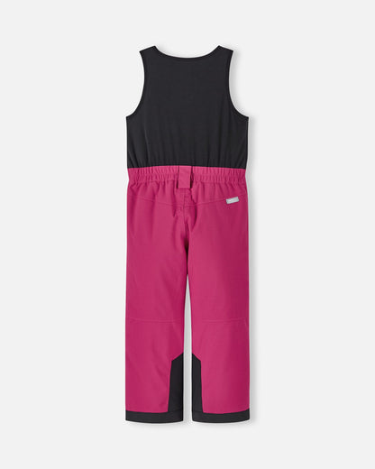 Back flat lay view of the rosy berry Reima Alppi kids' ski bibs, showcasing the stretchy black fleece upper back for comfort, an elasticized waist, and bright pink waterproof lower pants.