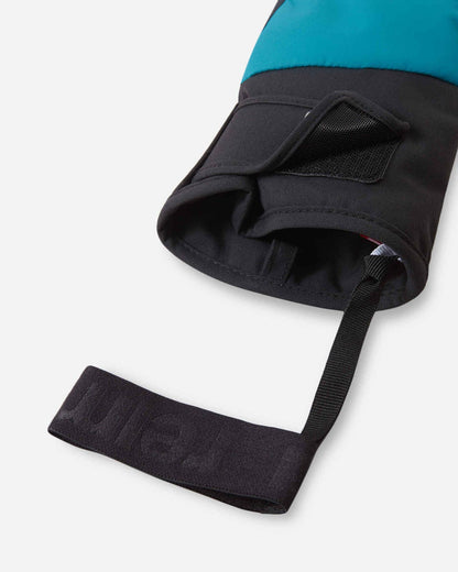 Close-up detail of the cuff opening on the Reima Hankas kids' ski gloves, highlighting the adjustable Velcro tightener, wide gauntlet cuff, and branded black elastic wrist leash.