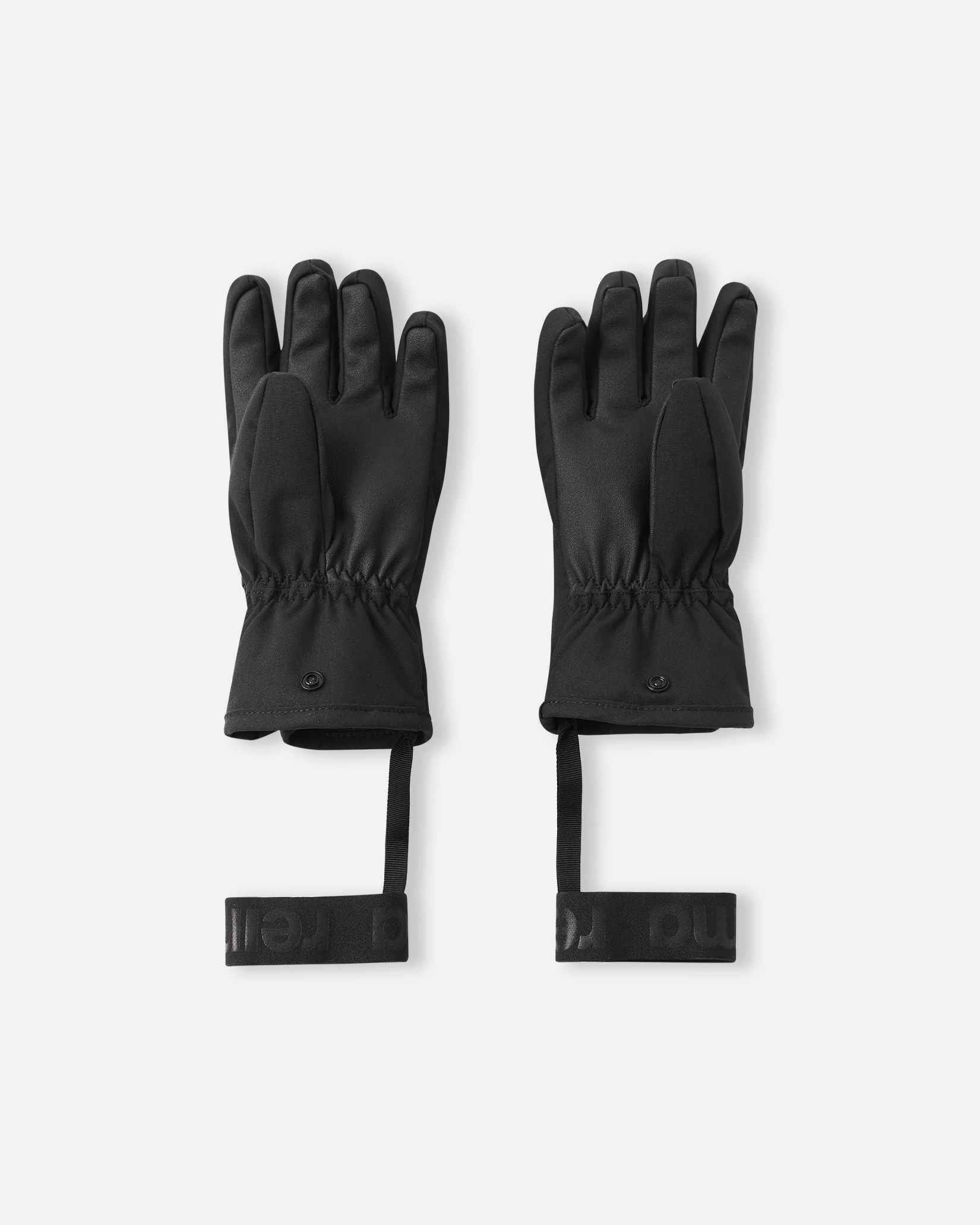 Flat lay view of the palms of the black Reima Hanskas kids' ski gloves, showcasing the highly durable reinforced gripping surface on the fingers and palms designed for securely holding ski poles during active winter sports.