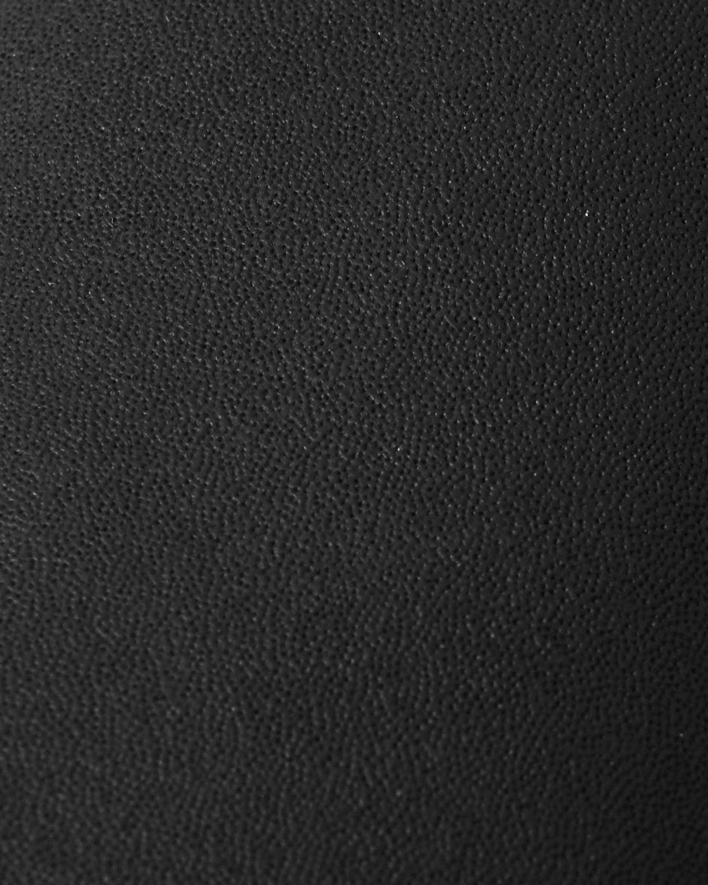 Macro close-up of the highly durable, textured black reinforced material used on the palms and thumbs of the Reima Hanskas kids' ski gloves, engineered for superior abrasion resistance and grip on the slopes.