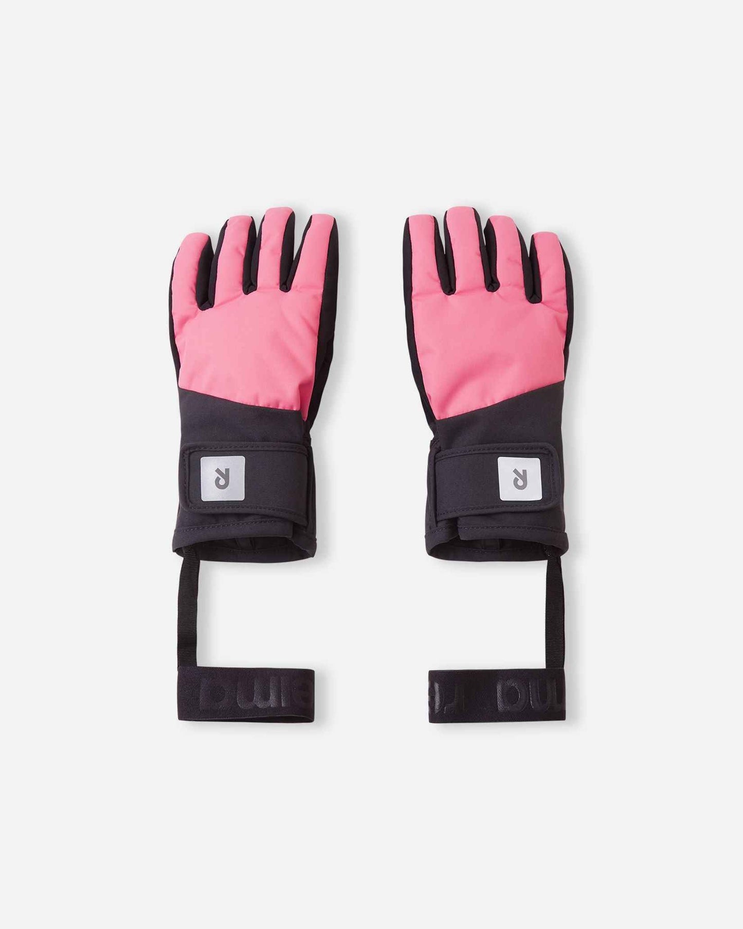 Flat lay view of the backs of the soft coral Reima Hanskas kids' ski gloves. The image highlights the waterproof ReimaTec fabric, an easy hook-and-loop adjustable wrist strap for a secure fit, and attached elastic safety wrist leashes.