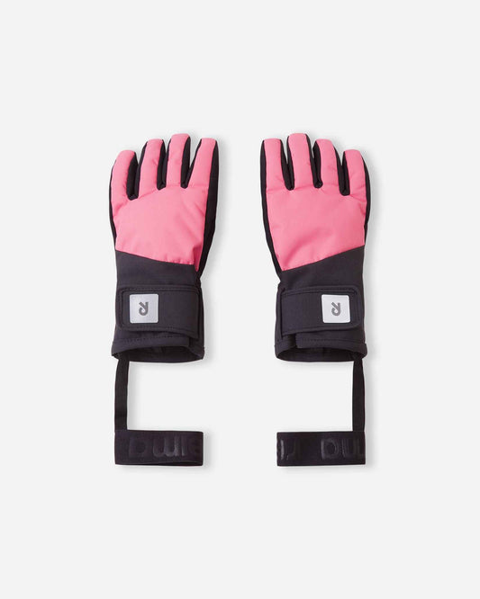 Flat lay view of the backs of the soft coral Reima Hanskas kids' ski gloves. The image highlights the waterproof ReimaTec fabric, an easy hook-and-loop adjustable wrist strap for a secure fit, and attached elastic safety wrist leashes.