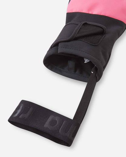 Close-up detail of the open cuff on the soft coral Reima Hanskas kids' ski gloves. The image highlights the attached black elastic safety wrist leash designed to prevent dropped gear and the easy hook-and-loop strap closure.