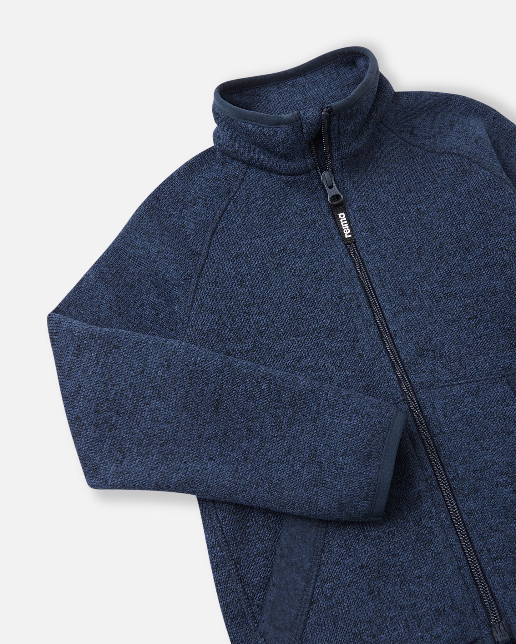 Close-up of the high collar and full-length zipper on the jeans blue Reima Hopper kids' fleece jacket, highlighting the smooth zipper operation and anti-chafe design.