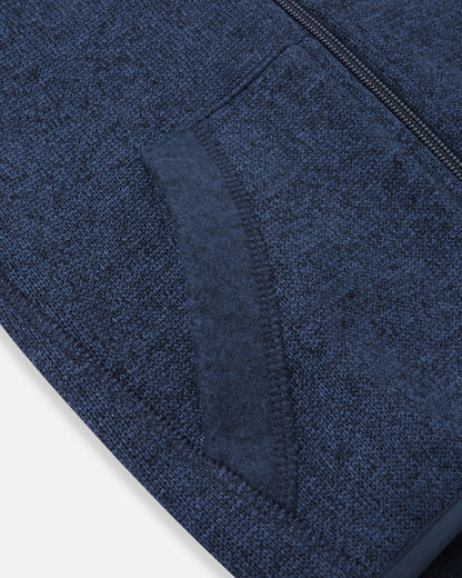Detail view of the front handwarmer pocket on the Reima Hopper kids' jeans blue knit fleece jacket, featuring reinforced stitching for durability.