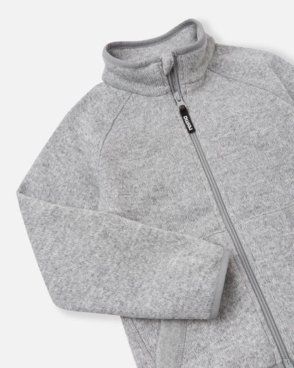Close-up of the high collar and full-length zipper on the melange grey Reima Hopper kids' fleece jacket, highlighting the smooth zipper operation and anti-chafe chin guard design.