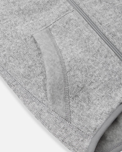 Detail view of the front handwarmer pocket on the Reima Hopper kids' melange grey knit fleece jacket, featuring reinforced stitching for extra durability.