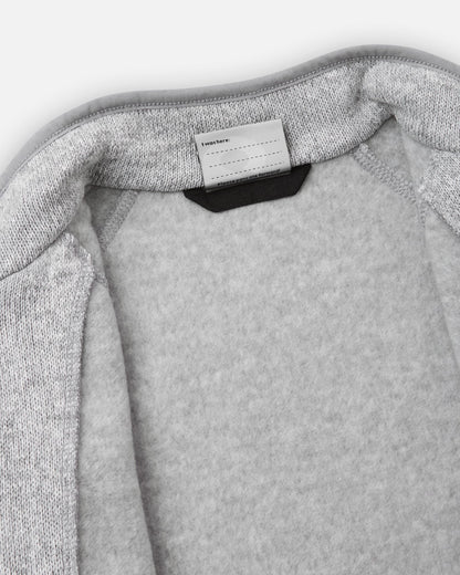 View of the inner neck label and writable name tag on the melange grey Reima Hopper kids' knit fleece jacket, showcasing the soft brushed fleece interior lining.