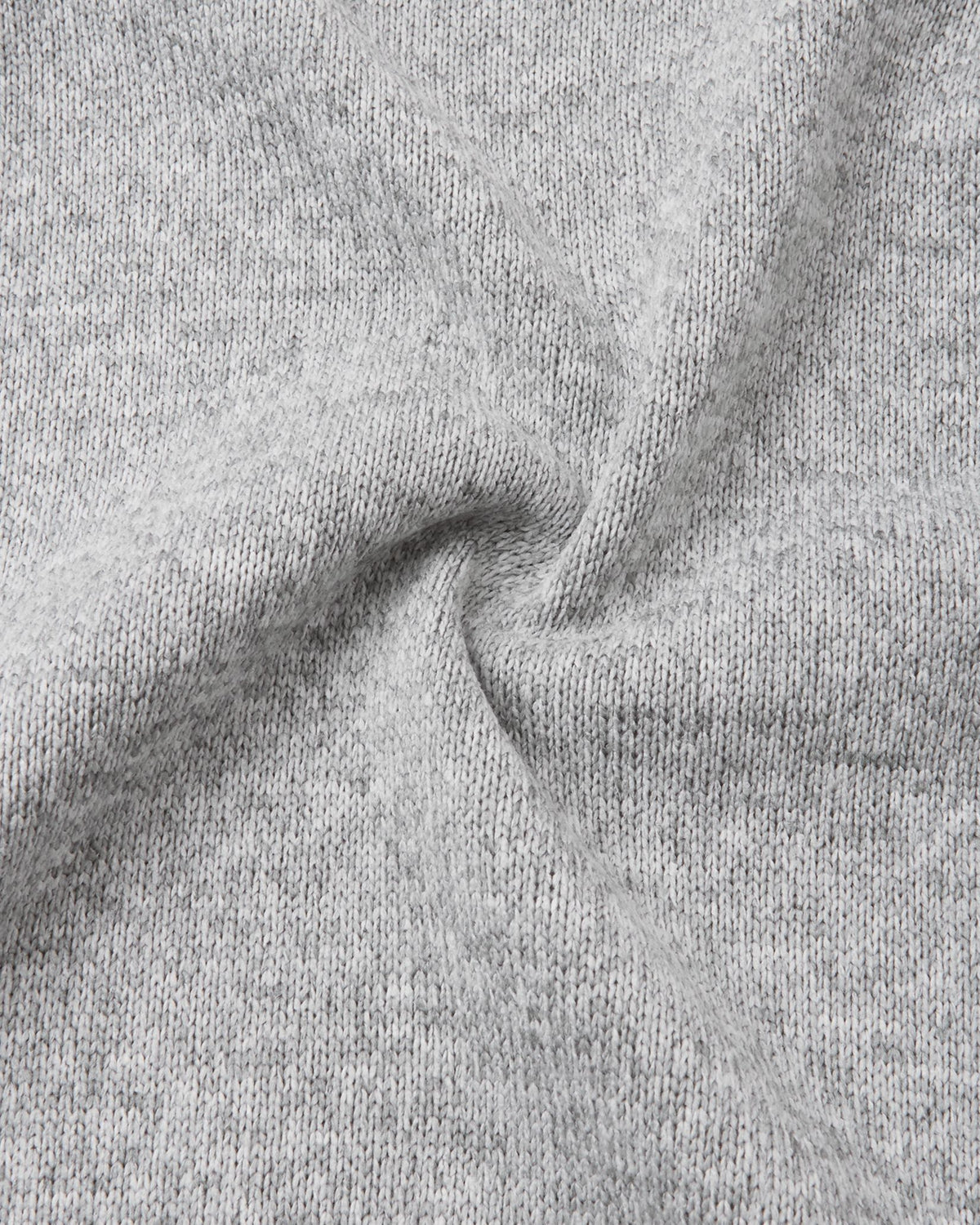 Macro close-up of the Reima Hopper kids' melange grey knit fleece fabric, demonstrating the high-quality, sweater-like texture and thermal mid-layer performance.