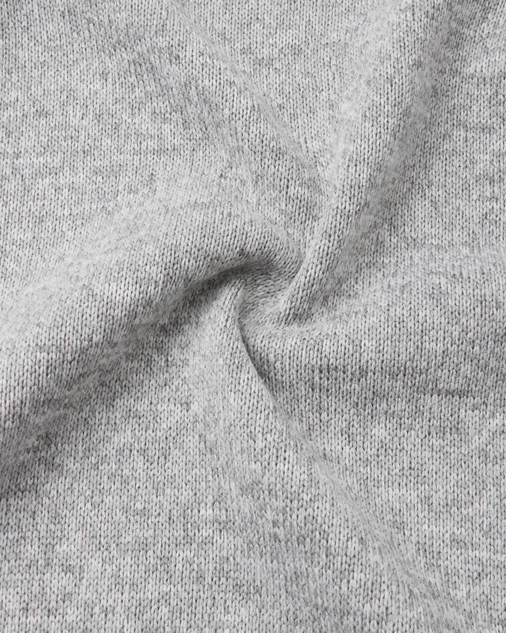 Macro close-up of the Reima Hopper kids' melange grey knit fleece fabric, demonstrating the high-quality, sweater-like texture and thermal mid-layer performance.