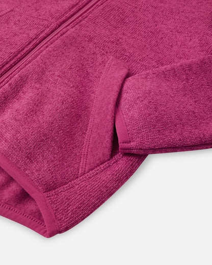 Detail view of the front handwarmer pocket on the Reima Hopper kids' rosy berry knit fleece jacket, featuring reinforced stitching for durability.