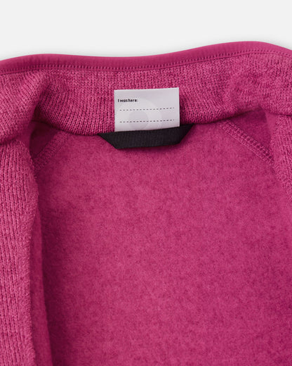 View of the inner neck label and writable name tag on the rosy berry Reima Hopper kids' knit fleece jacket, showcasing the soft brushed fleece interior.