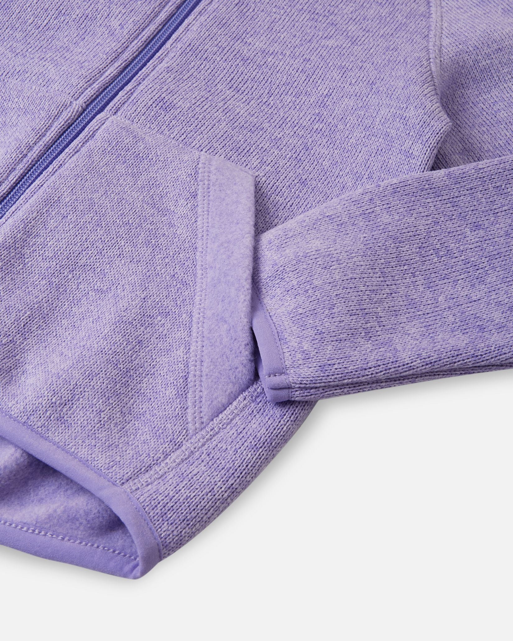 Detail view of the front handwarmer pocket on the Reima Hopper kids' blooming lilac knit fleece jacket, featuring reinforced stitching for extra durability.