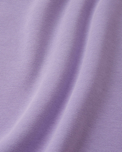 Macro close-up of the ultra-soft, breathable organic cotton terry fabric used on the blooming lilac Reima Huppis kids' hoodie, showing the high-quality knit texture.