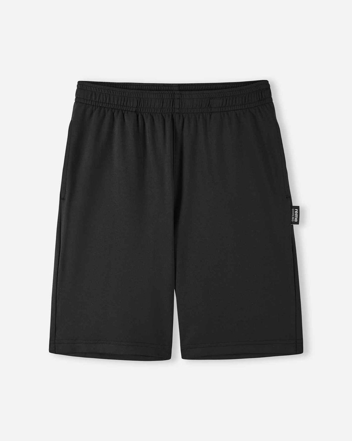Front view of the Reima Ilmassa kids sunproof shorts in solid black, featuring an elastic waistband, side pockets, and a small logo tag on the left side seam.