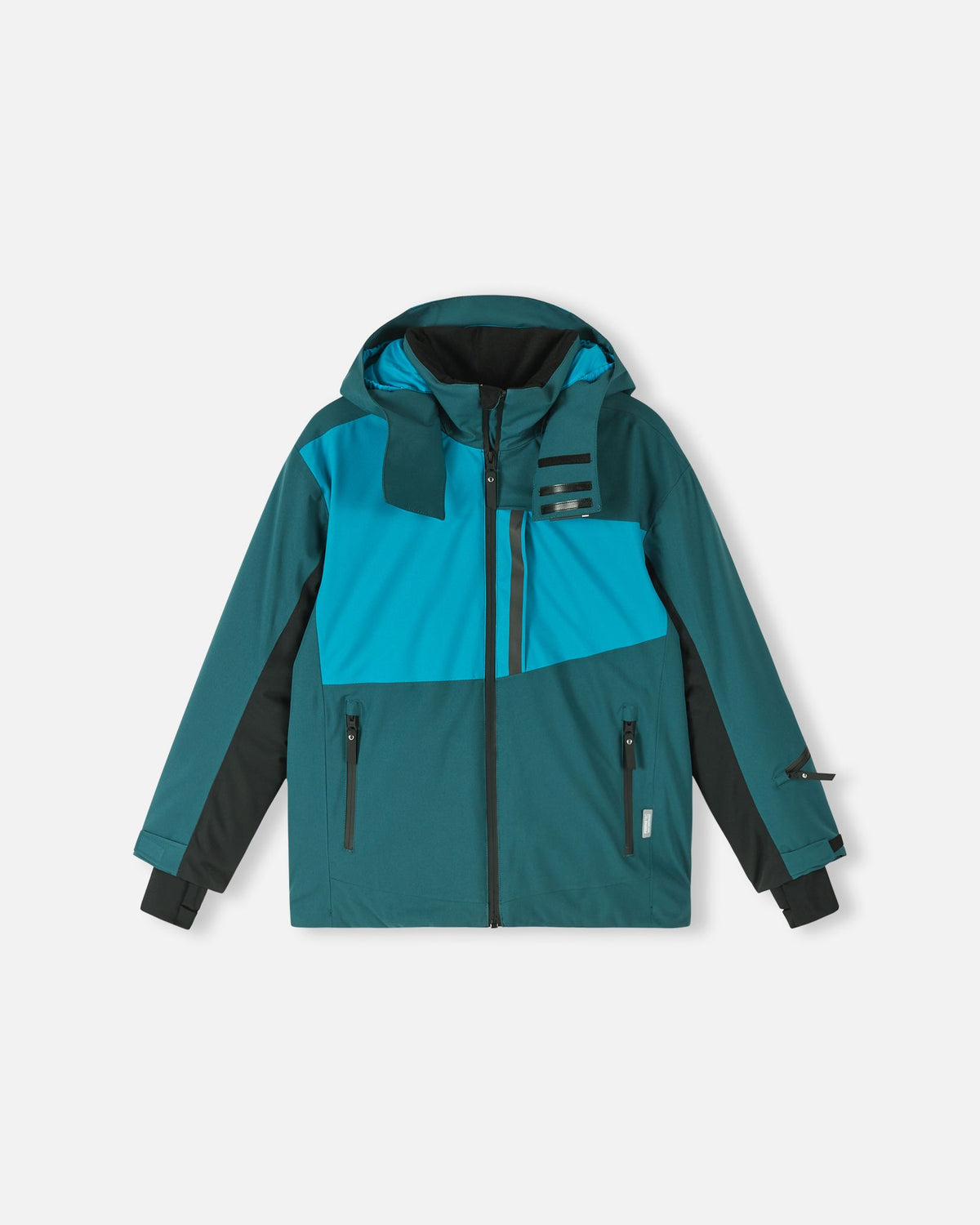 Front flat lay view of the dark teal Reima Jatuni kids' ski jacket. The image highlights the vibrant blue and teal color blocking, a safe detachable hood, and multiple zippered waterproof pockets designed for active winter sports on the mountain.