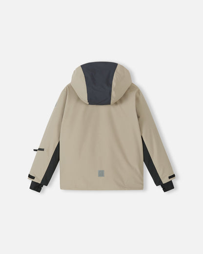 Back flat lay view of the earthy beige Reima Jatuni kids' winter ski jacket, showcasing the color-blocked detachable hood, adjustable sleeve cuffs, and a lower-back safety reflective Reima logo.