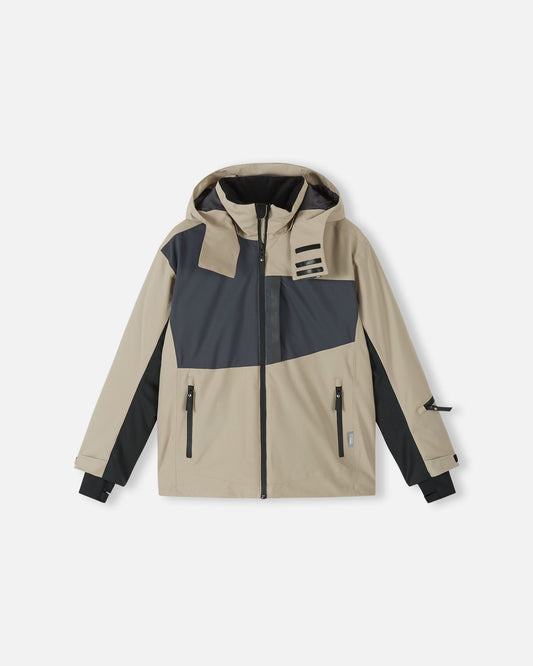 Front flat lay view of the earthy beige Reima Jatuni kids' ski jacket, featuring dark grey color blocking, a detachable hood, and multiple zippered waterproof pockets designed for active winter sports.