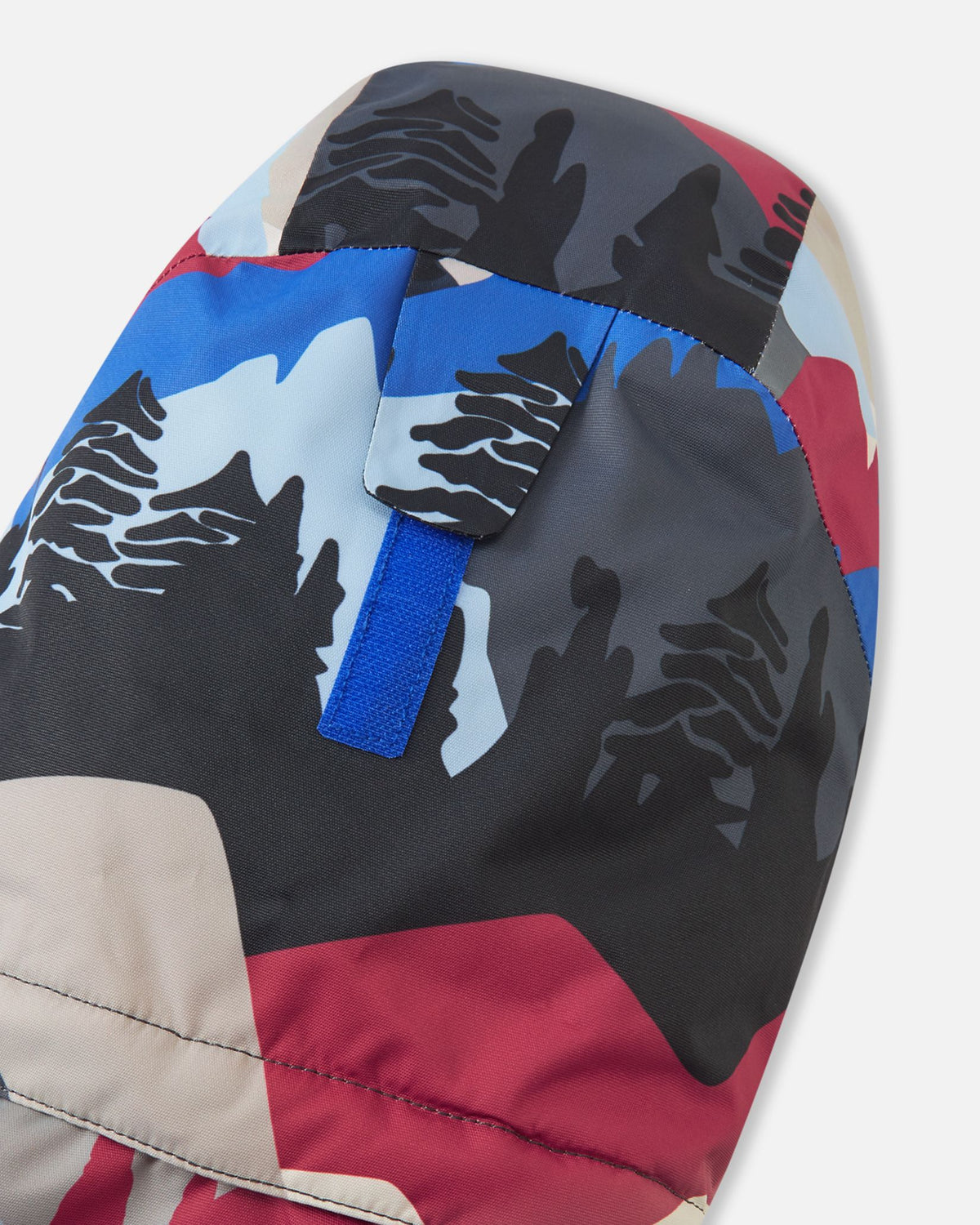 Close-up of the back of the hood on the Reima Kairala kids' ski jacket, featuring a Velcro adjustment tab designed to customize the fit, depth, and peripheral vision over a ski helmet or winter beanie.