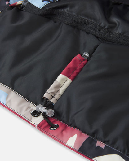 Close-up detail of the inner bottom hem on the Reima Kairala high-quality kids' winter ski jacket, featuring an adjustable elastic bungee cord and secure toggle lock designed to seal out cold drafts.