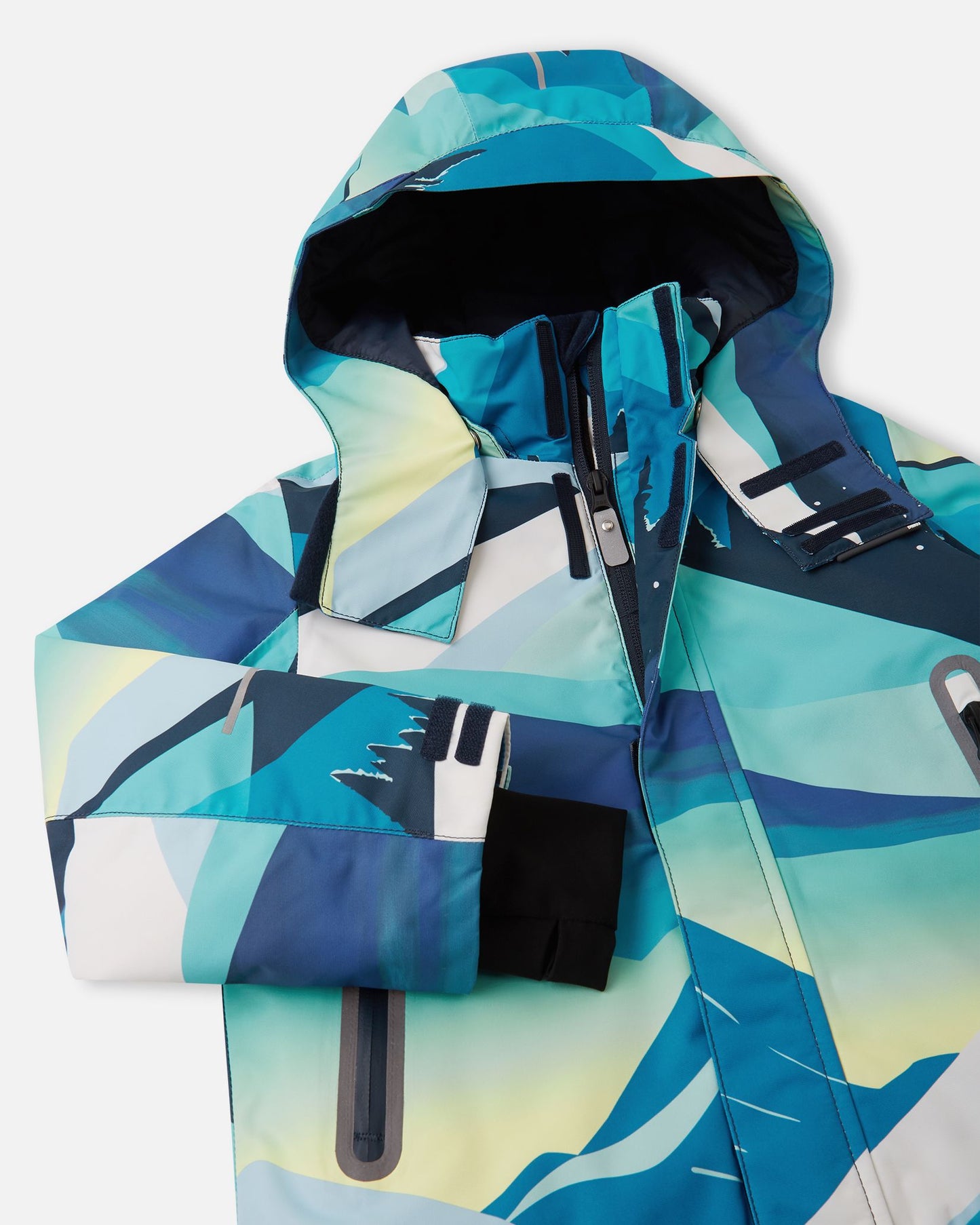 Close-up detail of the protective chin guard, storm flap, and secure collar snap buttons on the bright blue Reima Kairala kids' waterproof ski jacket.