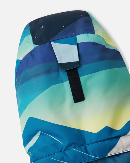 Close-up view of the rear velcro adjustment strap on the helmet-compatible hood of the bright blue Reima Kairala kids' waterproof ski jacket.