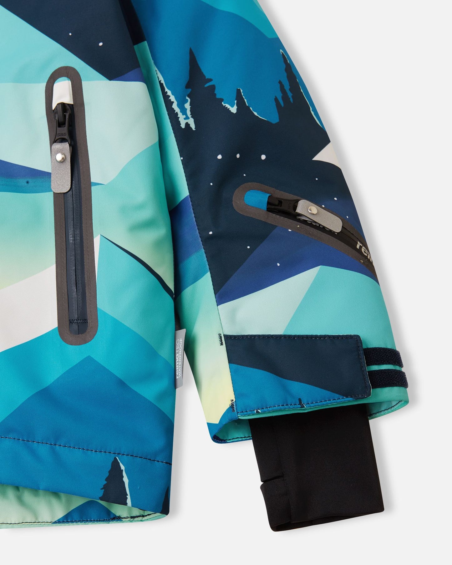 Close-up of the lower sleeve on the bright blue Reima Kairala kids' ski jacket, highlighting the waterproof zippered ski pass pocket, adjustable velcro cuff, and inner lycra thumbhole cuff.