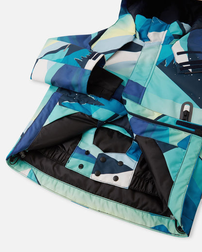 Detail view of the internal snap-button powder skirt inside the bright blue Reima Kairala kids' ski jacket, designed to keep out snow and cold drafts during winter activities.