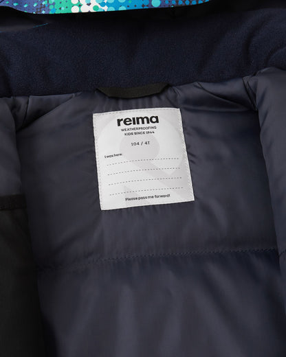 Close-up of the interior Reima name tag sewn into the smooth winter lining of the twilight blue Kairala kids' waterproof ski jacket.