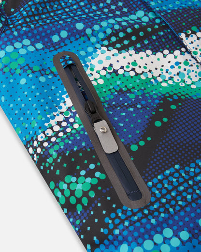 Close-up of the sealed, water-resistant zipper pocket on the front panel of the twilight blue Reima Kairala kids' winter ski jacket, showcasing the durable construction designed for snow sports.