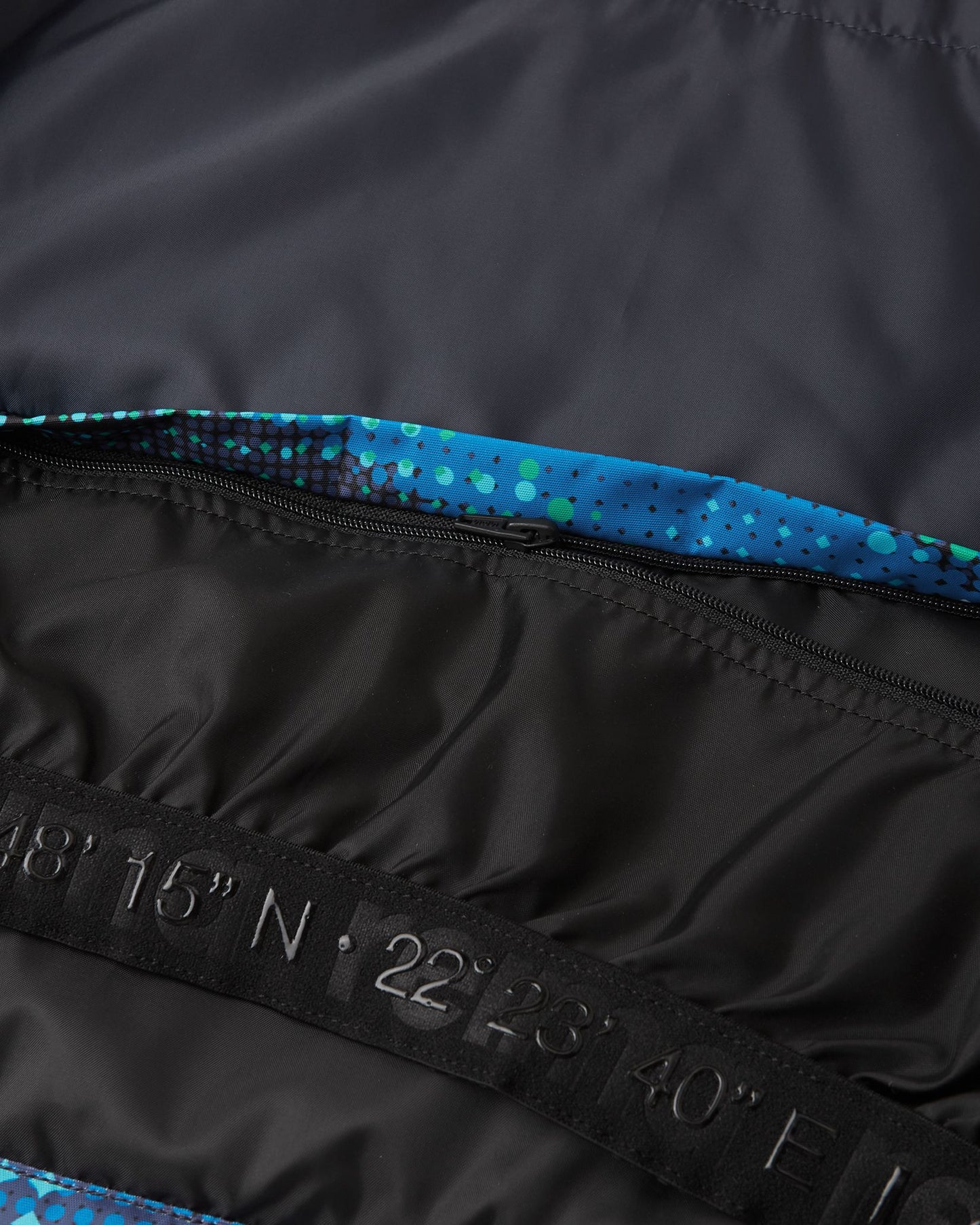 Close-up detail of the internal elastic snow powder skirt with a secure snap closure inside the twilight blue Reima Kairala kids' winter ski jacket.