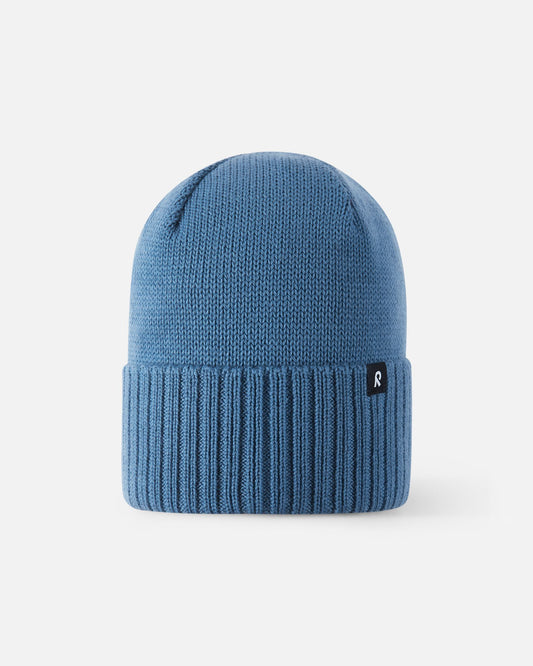 Front view of the Reima Kalotti boys' winter hat in ocean blue, showcasing the premium merino wool knit and classic ribbed fold-over brim.