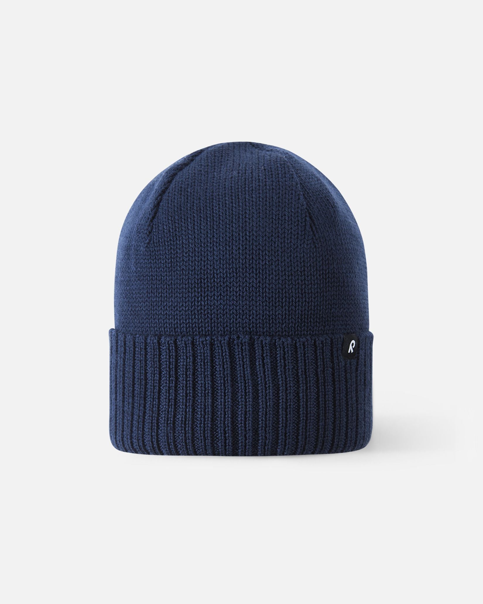 Front view of the Reima Kalotti kids' merino wool beanie hat in classic navy blue, featuring a ribbed fold-over brim.