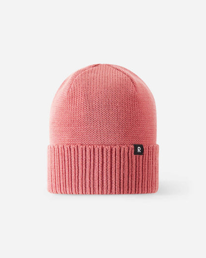 Front view of the Reima Kalotti kids' merino wool winter beanie in rose blush pink, featuring a classic knit crown, a ribbed fold-over cuff, and a small black Reima logo tag on a light background.