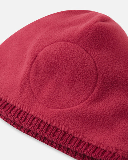 Inside out view of the cranberry red Reima Kalotti children's winter beanie, revealing the strategically placed circular fleece headband lining that adds a layer of gentle comfort and windproof protection specifically around the ears.