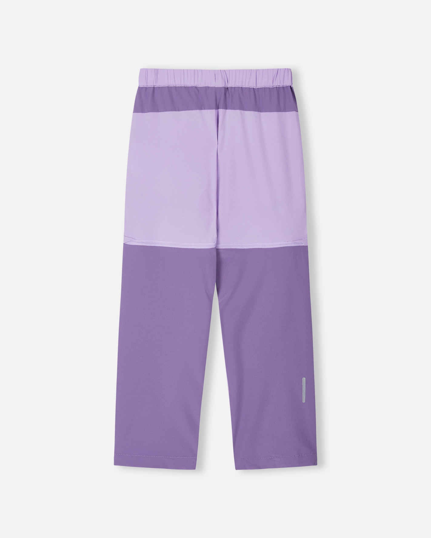 Back view of the blooming lilac Reima Kaveris kids' hiking pants, displaying the two-tone color block style, durable outdoor construction, and a reflective safety strip on the lower calf.
