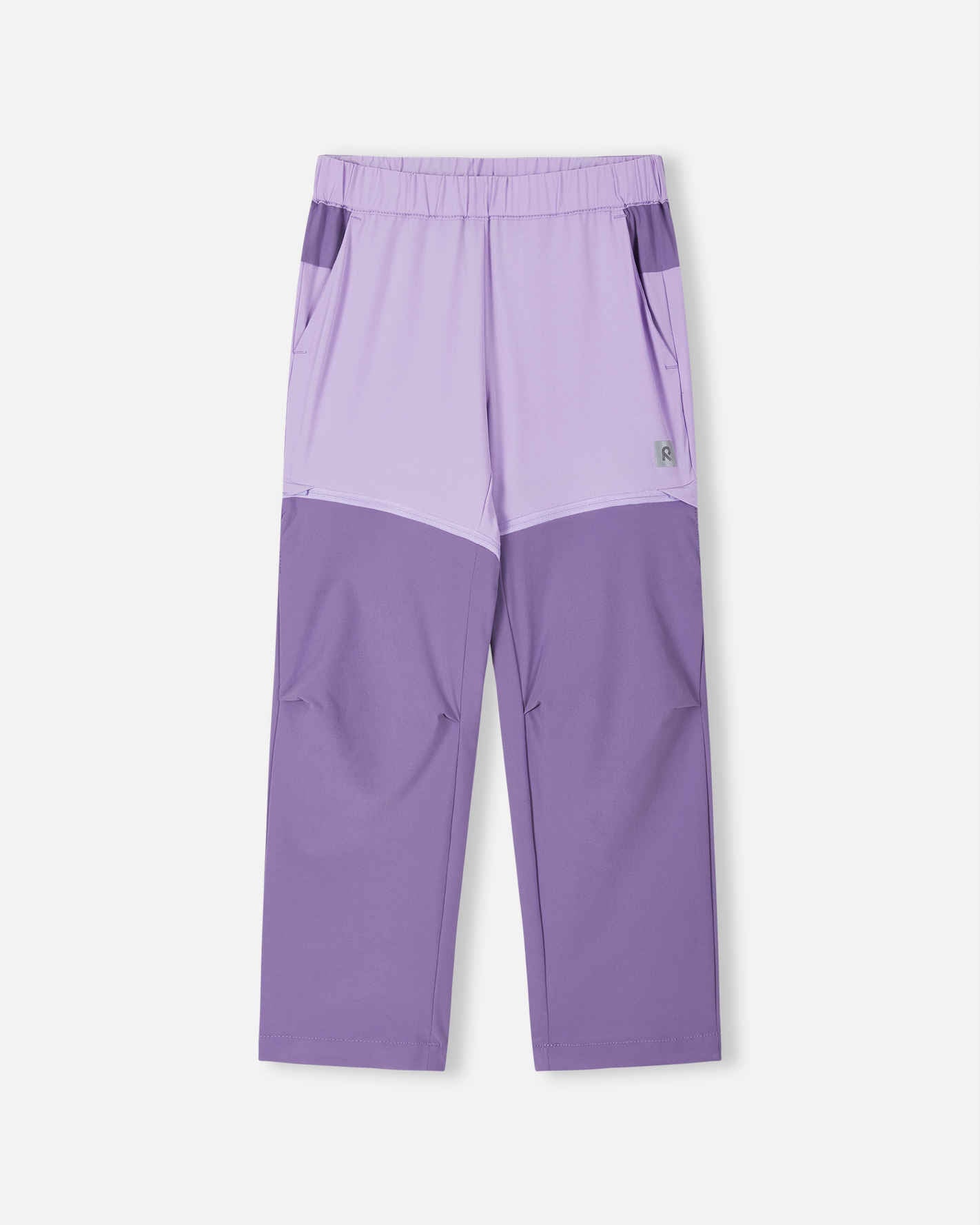 Front view of the Reima Kaveris kids' convertible hiking pants in blooming lilac, featuring a stylish two-tone purple design with darker reinforced lower legs and hidden zippers to seamlessly convert into summer shorts.