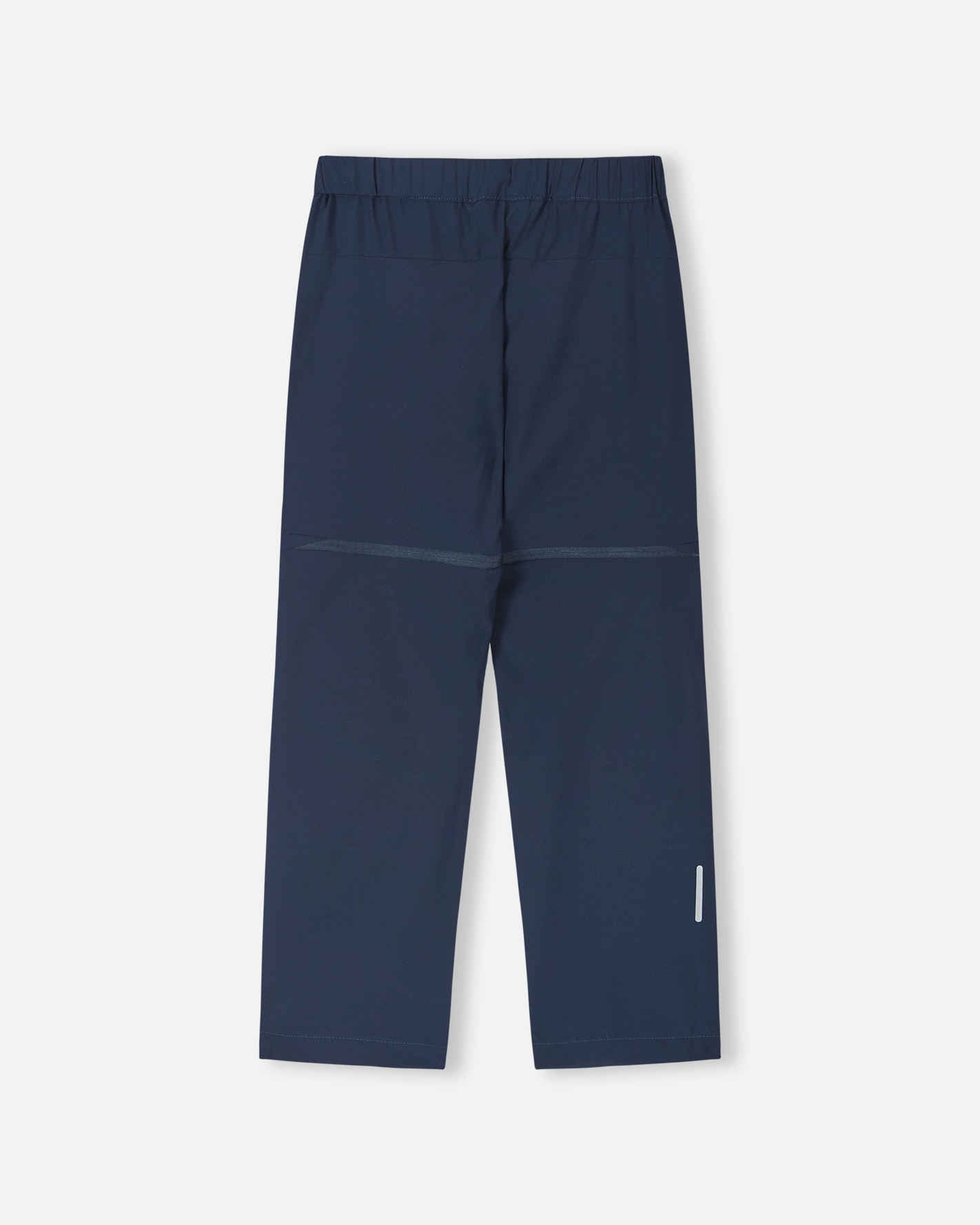 Back view of the navy blue Reima Kaveris kids' hiking pants, showcasing the durable, stretch outdoor fabric, articulated knee seams, and a reflective safety detail on the lower right leg for trail visibility.
